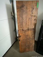 Top view of wooden shelf showing wood grain, knots and surface wear.