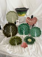 Overall view of nine majolica-style cabbage and leaf dishes