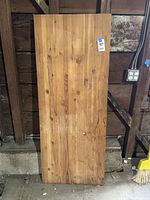 Front view of large butcher block slab showing natural wood grain and minor wear