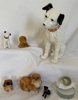 Overview of all six dog figurines and glass dog marble, showing size and variety.