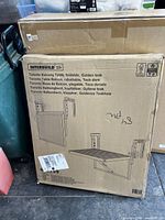 Boxed Interbuild Toronto Balcony Table showing foldable design and mounting bracket illustration