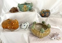 Lot of eight vintage animal figures on white fabric backdrop with perspective showing all pieces