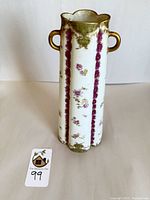 Full front view of Haviland Limoges porcelain vase showing rosebud floral patterns and gold handles