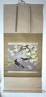 Full view of hanging scroll showing two birds and heartleaf vine on taupe background with gold brocade mount.