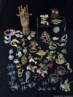 Full overview of all sea-themed brooches and pins displayed on black background
