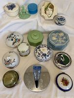 Overhead view showing all 15 lidded containers on white fabric