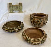 All four pieces arranged on white backdrop showing handled jardiniere, two low bowls, and double bud vase