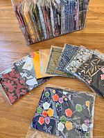 Assorted kimono silk fabric pieces neatly packed in a clear container, showcasing variety of colors and patterns