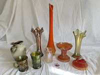 Nine items—front and back rows—arranged on white cloth