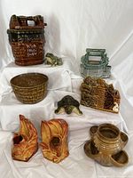 Full lot view showing 9 pieces including cookie jar, planters, figurines, and bookends arranged on white fabric.