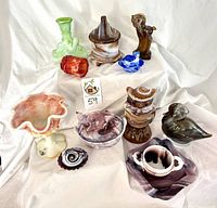 Group shot of all eleven slag glass pieces on white backdrop