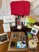 Full lot displayed on wood table, showing all boxes, cases and accessories included in the lot