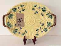 Front view of platter on stand showing full decorative motif