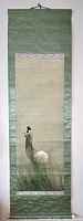 Full view of the hanging scroll showing woman playing flute under moonlight with sage green silk brocade border