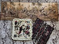Full view of three vintage decorative textiles: jacquard tapestry panel, needlepoint pillow cover, and tribal textile fragment.