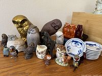 Wide view of grouping showing all owl items including planters, figurines, dishes, and book stand