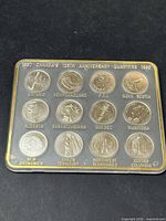 Two sets of Canadian 125th Anniversary quarters from 1992 in plastic holders, showing all provincial designs.