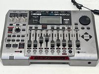 Top down image of the full Boss BR-900CD digital recording studio showing all controls and faders