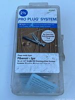 Closed box of Deckfast 2 1/2 inch Pro Plug System kit with label detailing contents and usage.