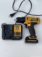 DeWalt DCD710 cordless drill with attached battery and DCB112 charger shown from the front.