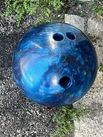 Top view displaying the three finger holes and blue-black marbled surface with minor surface wear.