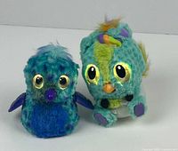 Two Hatchimals animal toys together showing their front sides.
