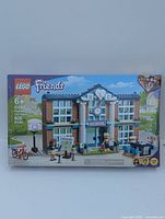 Full box front image showing Lego Friends Heartlake City School set with school building, minifigures, and accessories.