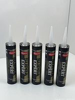 Front view of five sealed tubes of Mulco Super Exterior Sealant positioned upright showing brand and labeling