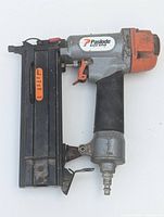 Side view of Paslode Lite Line F18-200 construction nailer showing metal body, black handle, and orange accents.