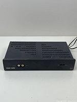 Front full view of black metal surveillance transceiver unit with ventilation slots and power cord