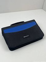 Closed view of the black and blue zip-closure DVD/CD organiser with handle