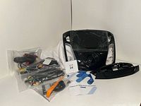 Full lot spread showing Android car stereo media player in dash frame, wiring harnesses, tools and manual.