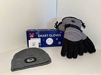 Heated gloves, LED beanie hat, and outer box labeled 'Smart Gloves' with snowflake graphics