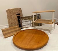 Photo of assortment including woven placemat, brown floral vase, bamboo spice rack, wood Lazy Susan, and two wood and metal display shelves