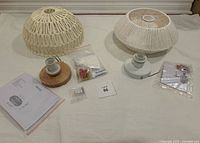 Two boho style woven ceiling light fixtures with accompanying mounting hardware and instruction manuals, shown from top and side angles.