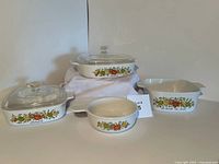 Photo showing full set of four CorningWare Spice of Life baking dishes on display including two lidded and two open dishes.