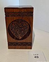 Front view of rectangular cremation urn showing heart-shaped tree of life motif and Celtic border engravings top and bottom.