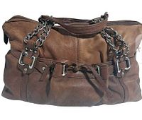 Front view of brown leather handbag showing two-tone design, buckle details, tied strap, and chain handles mixed with leather.