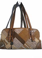 Front view of brown Fossil shoulder bag with canvas and leather patchwork design and strap buckles