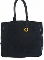 Front view of the large black tote showing the textured faux wool material, leather handles and gold-tone ring detail