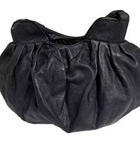 Front angled view showing gathered, ruched soft black leather with two sturdy rounded handles.