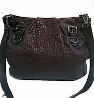 Front view showing dark brown crinkle leather, buckle, D-ring and adjustable leather strap.