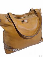 Front view of the yellow leather Robert Dice bag showing the zippered pocket and shoulder straps.