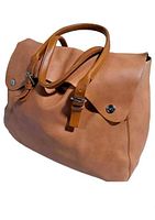 Front angle of large tan leather bag showing two flap sections with silver snap closures and leather buckle straps. Rounded leather handles visible.