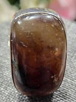 Close-up image of the polished rectangular Baltic amber stone set in sterling silver.