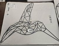 Metal wall art geometric hummingbird piece with angular, geometric lines, black metal.