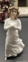 Front angle view of Royal Doulton Forget Me Not figurine showing facial features and upper body details