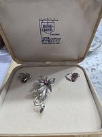 Original box interior showing Bond Boyd logo and three-piece sterling silver jewelry set featuring a butterfly brooch and matching earrings with pink stones.