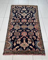 Full view of the rectangular Hamadan rug showing all over floral and geometric pattern with borders.