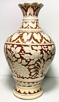 Front view of antique large hand painted ceramic vase with floral brown and cream motifs, showing overall shape and design.